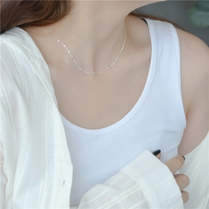 Minimalist S925 sterling silver shimmering disk necklace worn on a female model