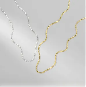 Detail of gold and silver S925 sterling silver Figaro link chain necklace set