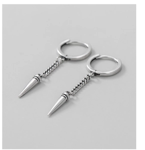 Detail of silver S925 punk chain earrings with edgy spike cone pendants for unisex style