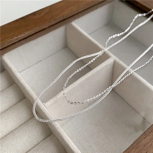 Macro shot of S925 sterling silver Chopin chain and O-link necklace with silky finish
