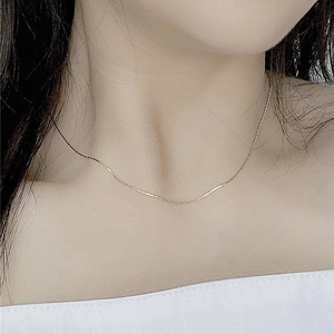 Minimalist S925 sterling silver thin gold chain necklace worn on a woman's neck