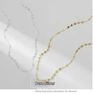 Detailed view of intertwined S925 sterling silver necklaces in gold and silver finishes