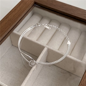 Detail of S925 sterling silver knotted bracelet featuring woven mesh and dual-line links