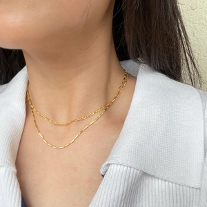 Double-layered gold S925 sterling silver Figaro necklace set worn by a female model