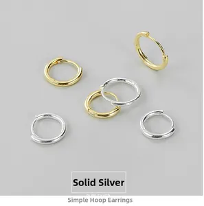 Detailed view of polished S925 sterling silver hoop earrings in gold and silver finish