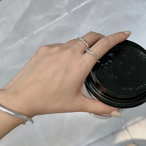 S925 sterling silver liquid streamline ring and beaded jewelry set on model holding coffee