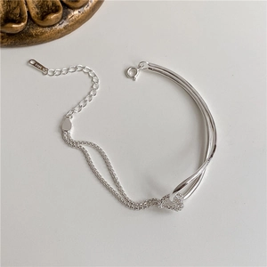 Detailed shot of S925 silver double-layer bracelet featuring a heart knot and lobster clasp