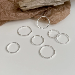 Detailed view of seven S925 sterling silver rings with irregular hammered textures