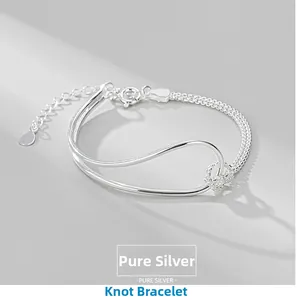 Macro detail of S925 sterling silver knot bracelet featuring dual-line minimalist design