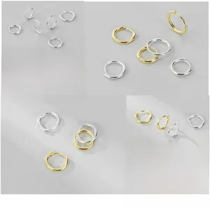 Detail of S925 sterling silver hoop earrings in gold and silver with hypoallergenic finish