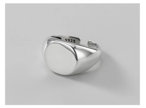 Macro shot of polished S925 sterling silver signet ring showing adjustable band and hallmark