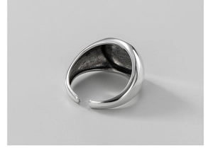 Close-up of adjustable S925 sterling silver ring with minimalist smooth geometric design