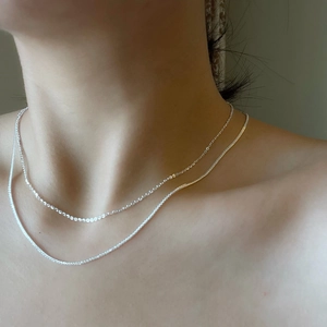 Elegant double layered S925 sterling silver Chopin chain necklace shown on neck