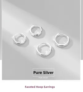Macro detail of S925 sterling silver faceted hoop earrings with geometric surface