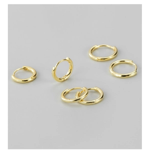 Detail shot of golden S925 sterling silver hoop earrings with clear hallmark stamp