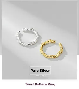 Detailed view of silver and gold twisted wire rings made of pure sterling silver
