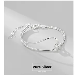 Detailed macro view of S925 sterling silver knot bracelet with fine woven chain texture