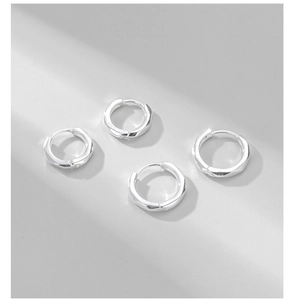 Macro shot of S925 sterling silver hoop earrings with geometric faceted design