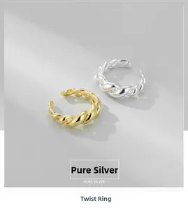 Close-up of gold and silver S925 sterling silver croissant rings in twisted design