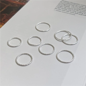 Set of 8 minimalist 925 silver hammered texture stacking rings on book page