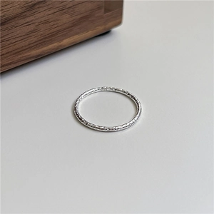 Detailed macro view of S925 sterling silver ring with unique hammered foil texture