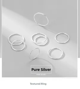 Close-up of hammered 925 sterling silver rings with irregular foil texture and glossy finish