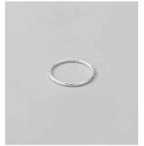 Macro view of 925 sterling silver ring featuring a unique hammered foil texture detail