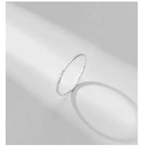 Macro detail of the 925 sterling silver ring featuring a hand-hammered textured finish
