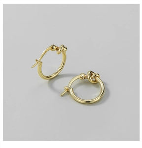 Detailed view of S925 sterling silver knotted hoop earrings with gold plated finish