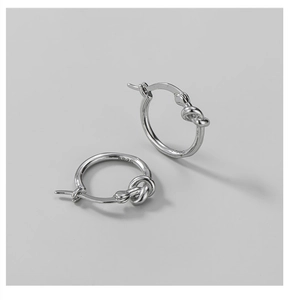 Detailed shot of S925 sterling silver knotted hoop earrings with authentic S925 hallmark