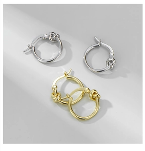 Detailed close-up of S925 sterling silver knotted hoop earrings in gold and silver finish