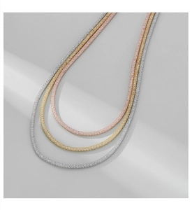 Detailed view of flexible mesh necklaces in silver, gold and rose gold finishes