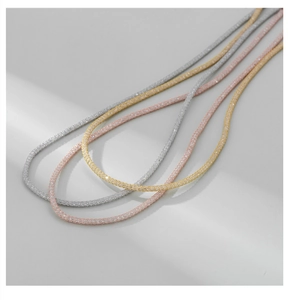 Macro view of S925 sterling silver mesh tube necklaces in silver, rose gold and gold finishes