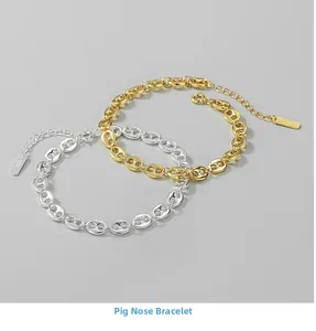 Detail of gold and silver S925 sterling silver anchor chain bracelets with polished finish