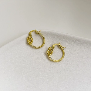 Minimalist S925 sterling silver twisted knot hoop earrings in a smooth golden finish