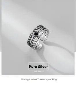 Detail of vintage 925 sterling silver triple heart ring with black stone and S925 stamp