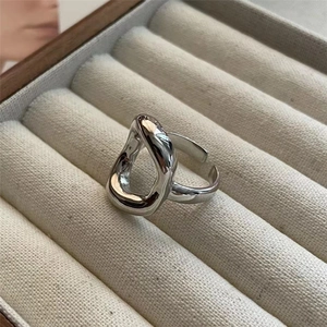 Detailed macro view of S925 sterling silver hollow geometric ring on beige velvet