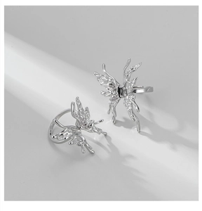 Detail of silver liquid butterfly rings with black gemstone in minimalist fluid style
