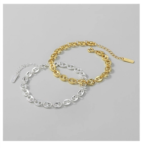 Detail of S925 sterling silver pig nose link bracelets in gold and silver finish