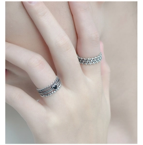 Detail of vintage 925 sterling silver stacked rings with black heart and woven texture