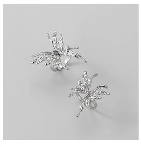 Detailed view of liquid metal butterfly ring with black gemstone and silver finish