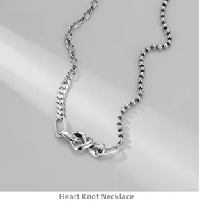 Détail du collier en argent S925 avec pendentif noeud de coeur et chaînes asymétriques