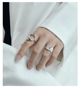 Detailed view of silver minimalist rings with unique fold texture and hollow geometric shapes