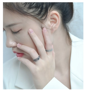 Detail of vintage 925 sterling silver multilayer rings with a black heart on finger