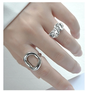 Detailed view of S925 sterling silver rings with liquid metal texture and oval design