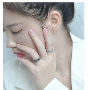 Close-up of vintage 925 silver layered ring with black heart detail on model's hand