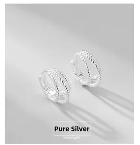 Detailed view of sterling silver double hoop earrings with twisted rope texture design
