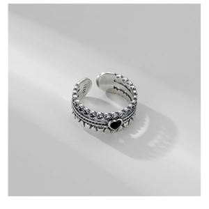 Detailed macro view of S925 sterling silver stamp on vintage black heart open ring
