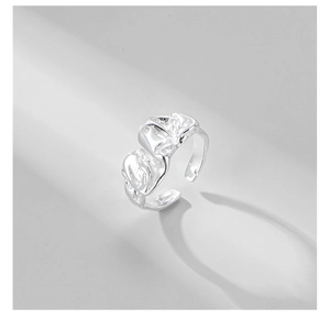 Detail showing irregular wrinkled texture and light effects on a silver metal ring
