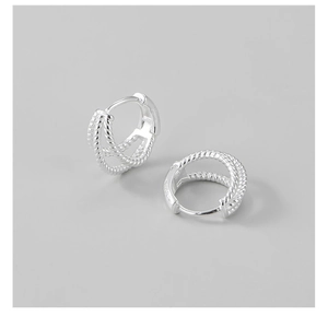 Detailed close-up of S925 sterling silver hoop earrings with woven twisted rope texture